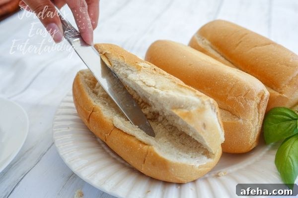 spreading butter onto french rolls as one of the best sandwich ideas!