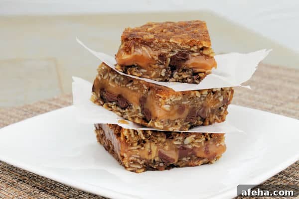 Carmelita Chocolate Caramel Bars Recipe — Chewy Chocolate Caramel Squares 2 carmeltia Chocolate Caramel bars stacked on top of each other with parchment paper between
