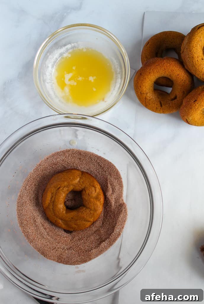 Spiced Gluten-Free Pumpkin Donuts: Soft Autumn Recipe 11 gluten free pumpkin donuts dipped in sugar in a glass bowl