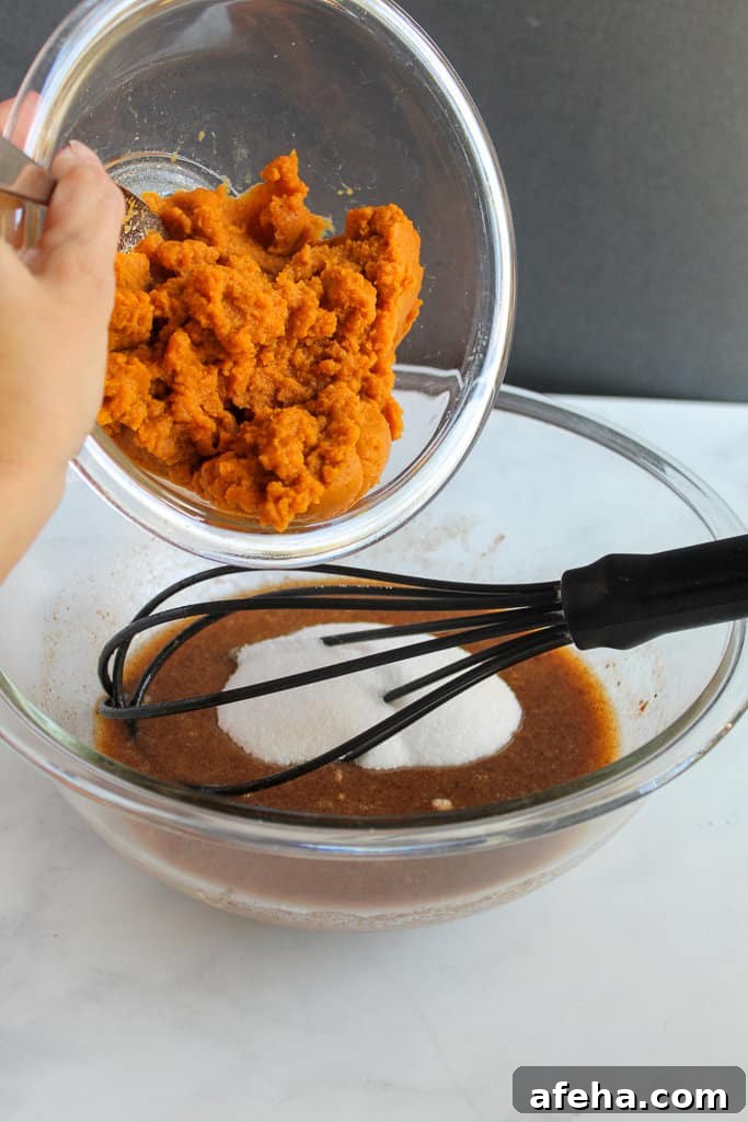 Spiced Gluten-Free Pumpkin Donuts: Soft Autumn Recipe 5 adding pumpkin to gluten free pumpkin donuts batter.