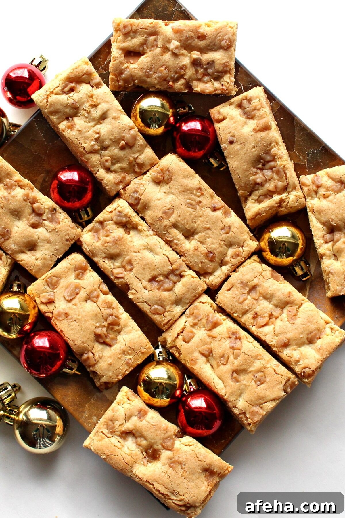 Blondie Bars  with butterscotch chips on a platter with Christmas ornament balls.