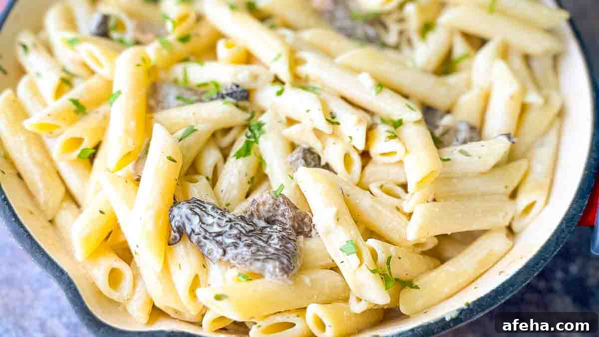 Morel Mushroom Pasta in a skillet, showing the creamy Boursin cheese sauce clinging to the pasta and mushrooms.