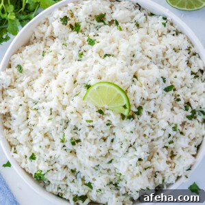A bowl of cilantro lime rice garnished with a lime slice.