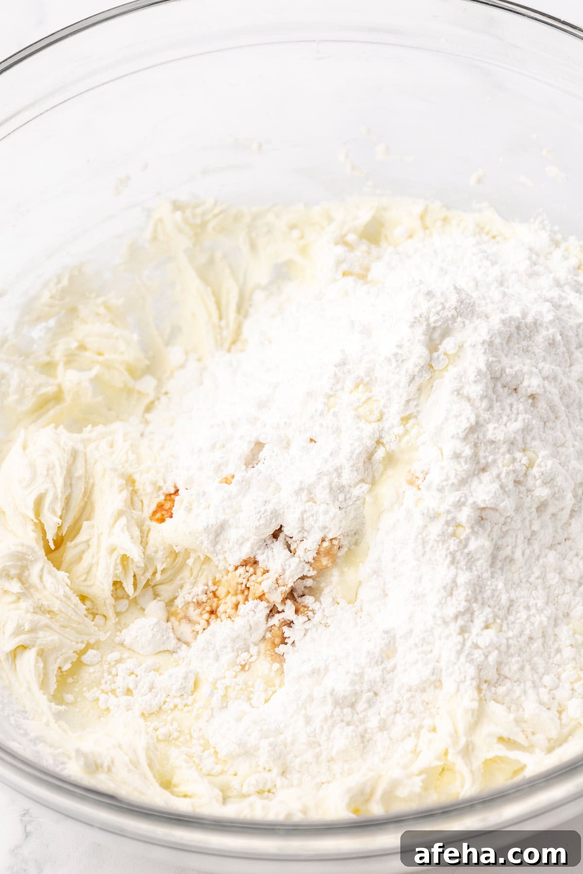 ingredients for butter mints in a clear glass bowl not yet combined