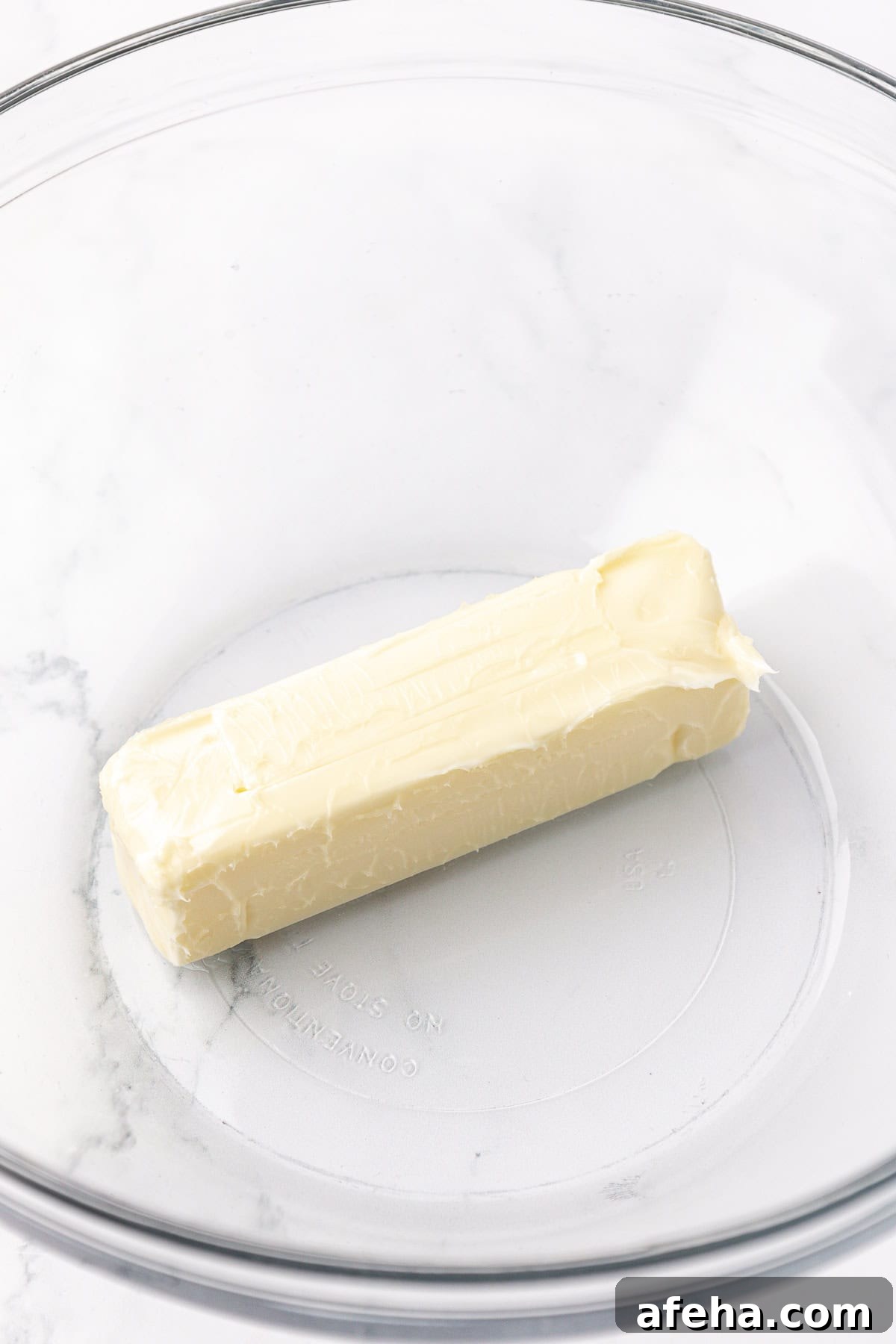 a stick of butter in a clear glass bowl