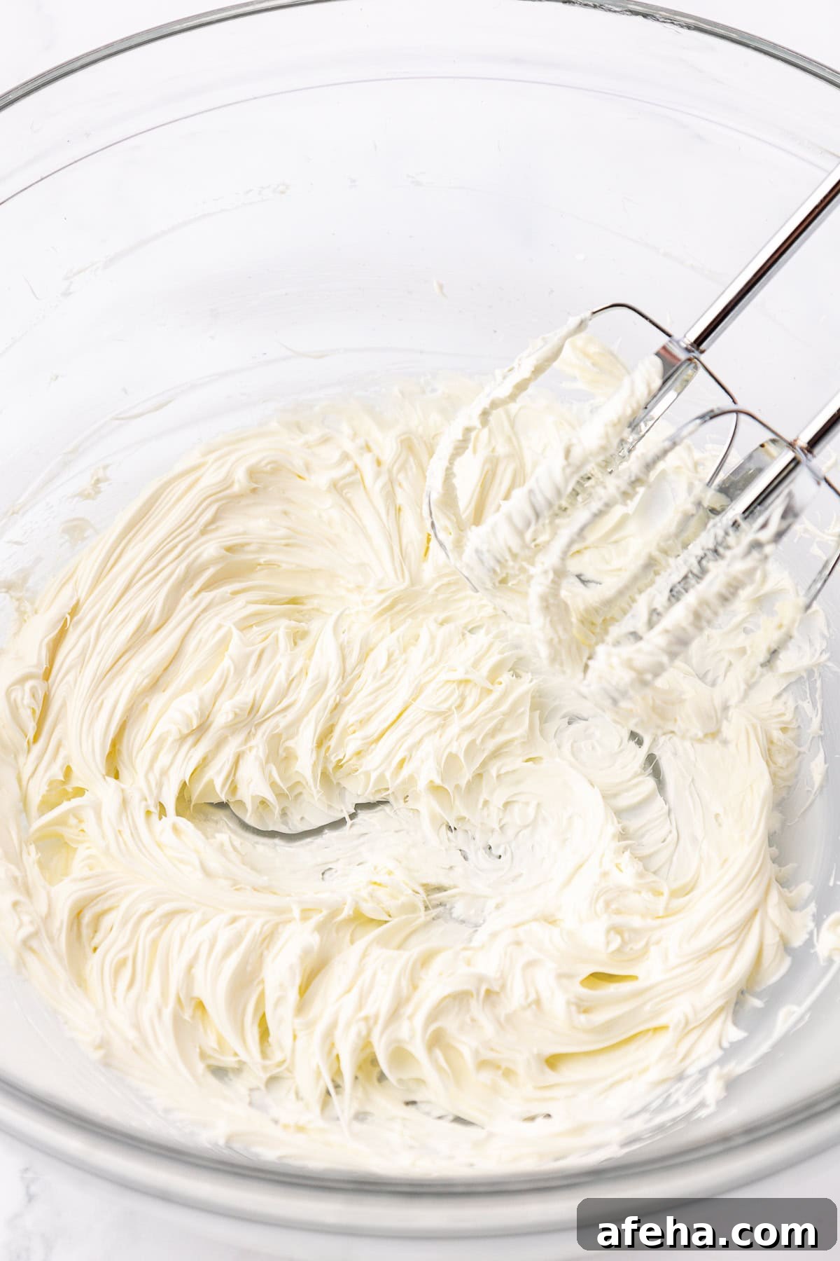 butter mint ingredients being creamed in a class bowl