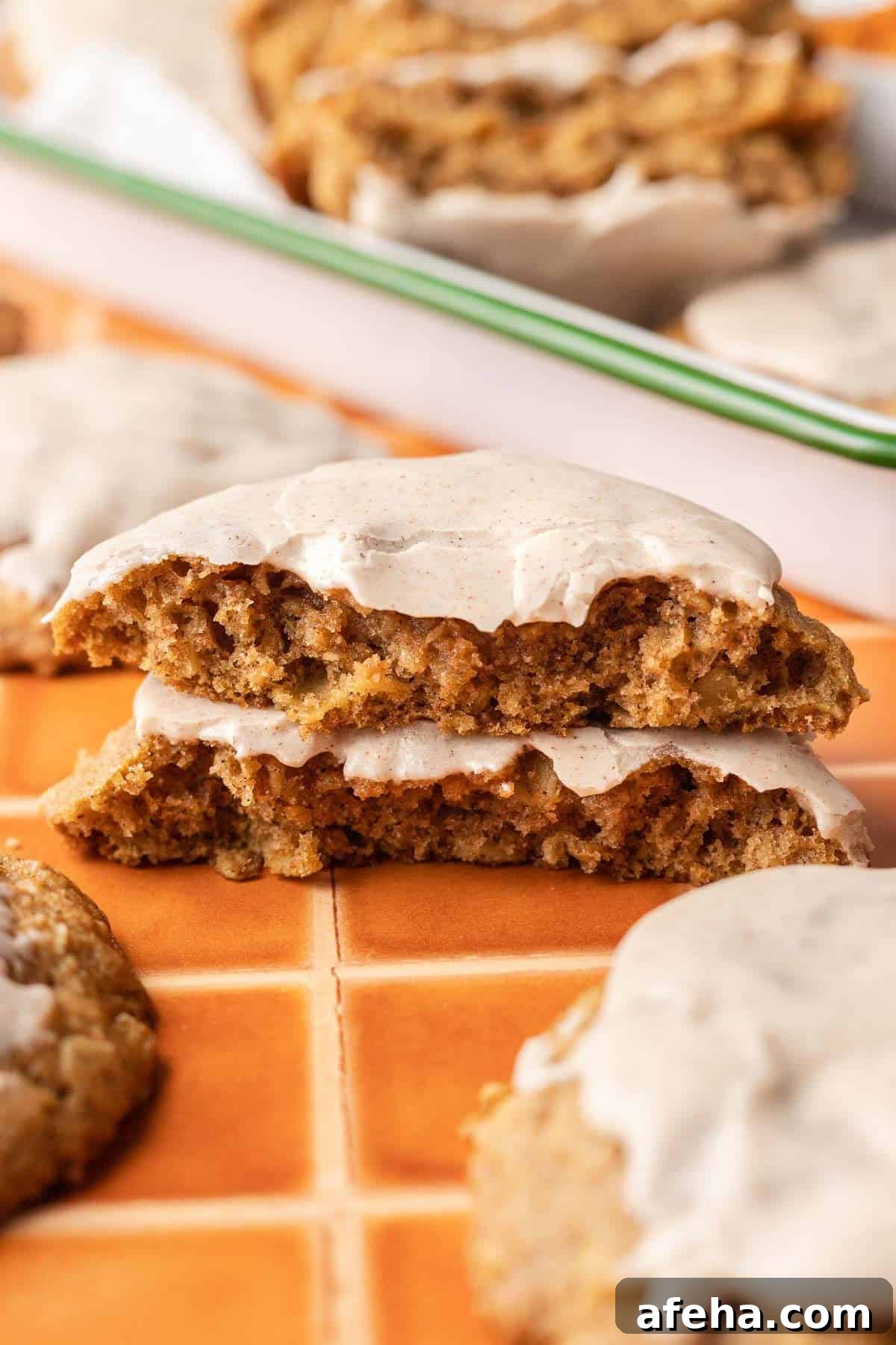 Iced Pumpkin Oatmeal Cookie split in half and stacked.