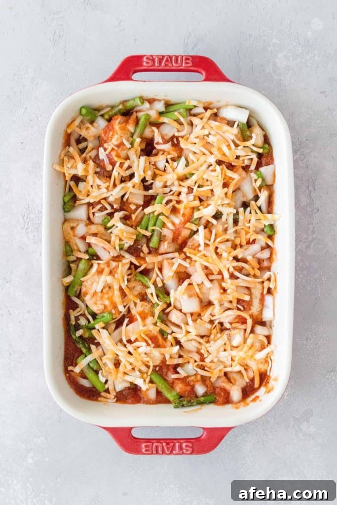 sauce, onions, asparagus, mixed into the baking dish with cheese sprinkled on top