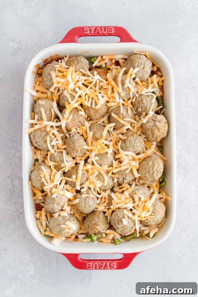 meatballs nestled in and sprinkle more cheese on top