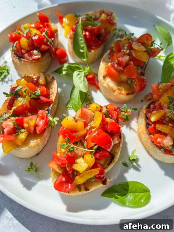 A plate of Italian Bruschetta featuring toasted bread slices topped with diced red and yellow tomatoes, garnished with fresh basil leaves and microgreens, served on a white plate.