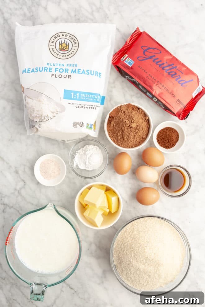 Top down image of chocolate cake ingredients on a grey and white marble surface.
