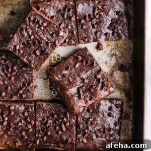 A tray of baked cottage cheese brownies, sliced into squares