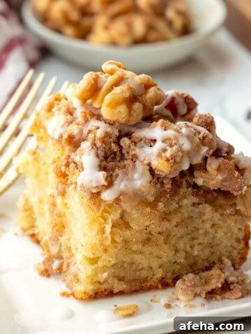 Baked banana coffee cake on plate with fork.