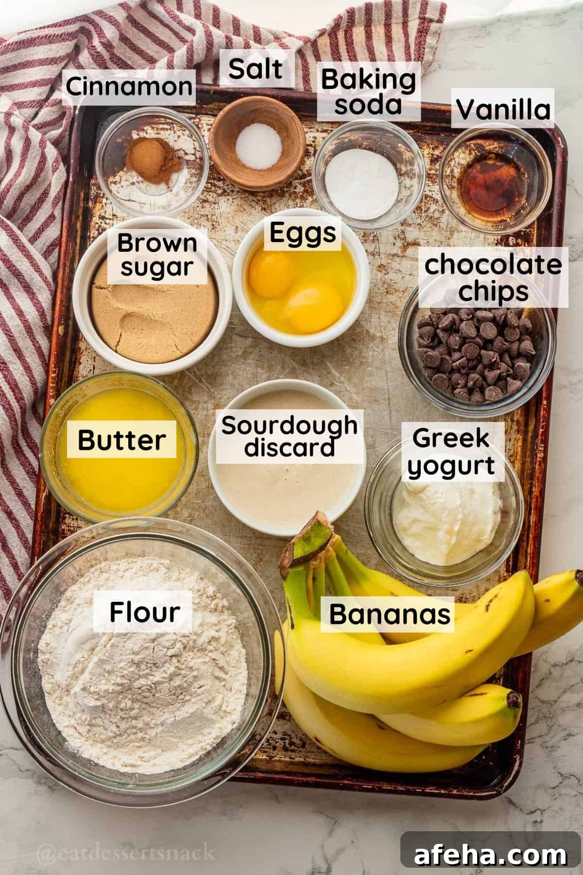 Labeled ingredients for sourdough discard banana bread on metal pan in glass dishes.