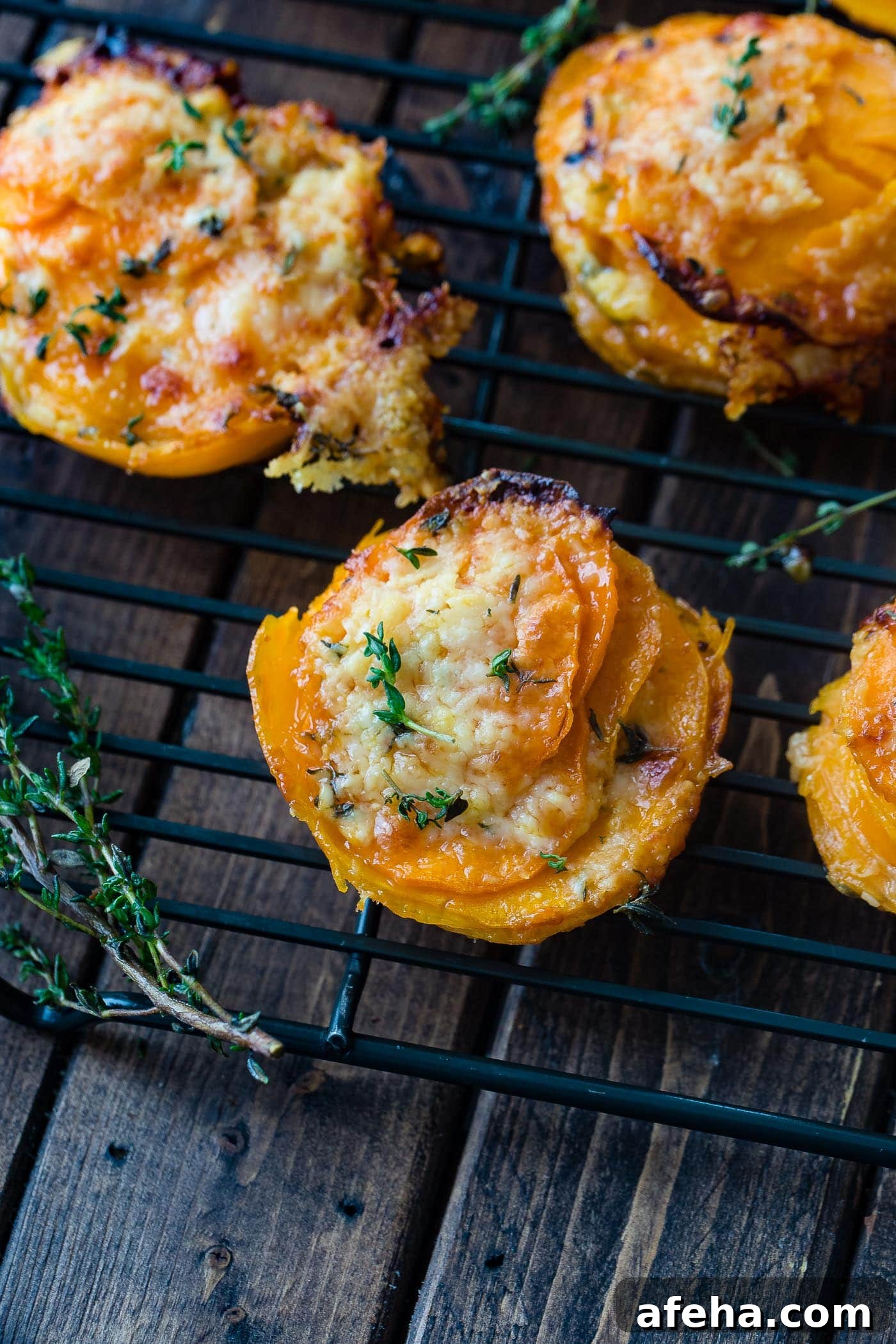 A photo of a sweet potato stack sitting on a wire cooling rack taken from above garnished with fresh time.