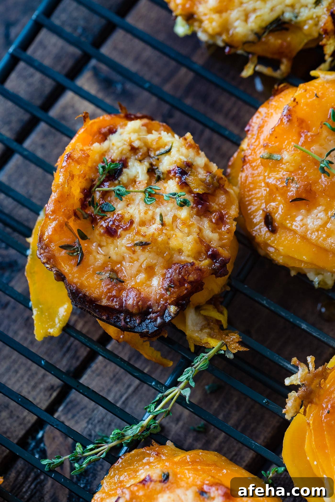 A photo of a sweet potato stack sitting on a wire cooling rack taken from above garnished with fresh time.