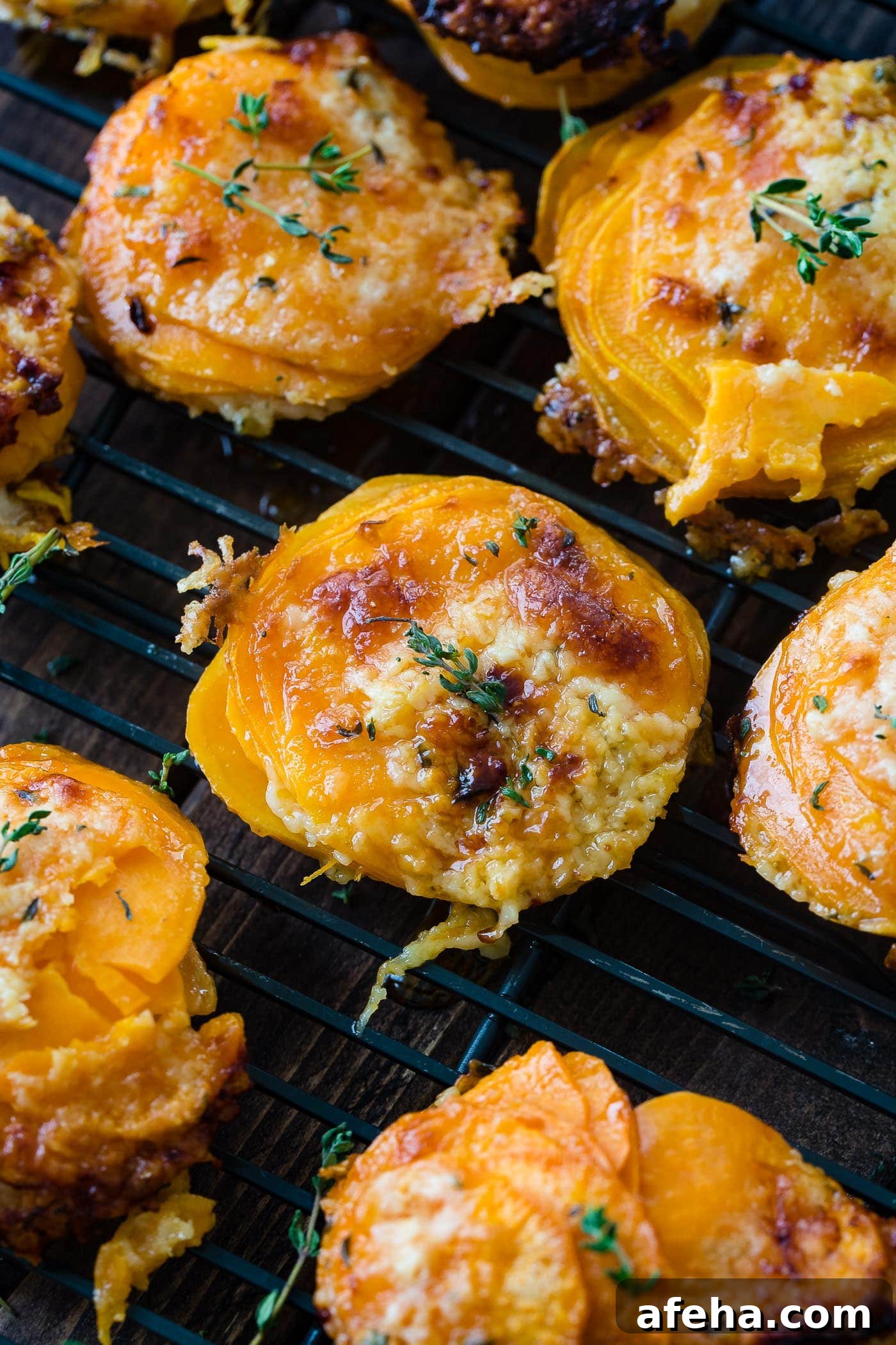 A photo of a sweet potato stack sitting on a wire cooling rack taken from above garnished with fresh time.
