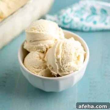 A bowl filled with scoops of homemade vanilla ice cream.