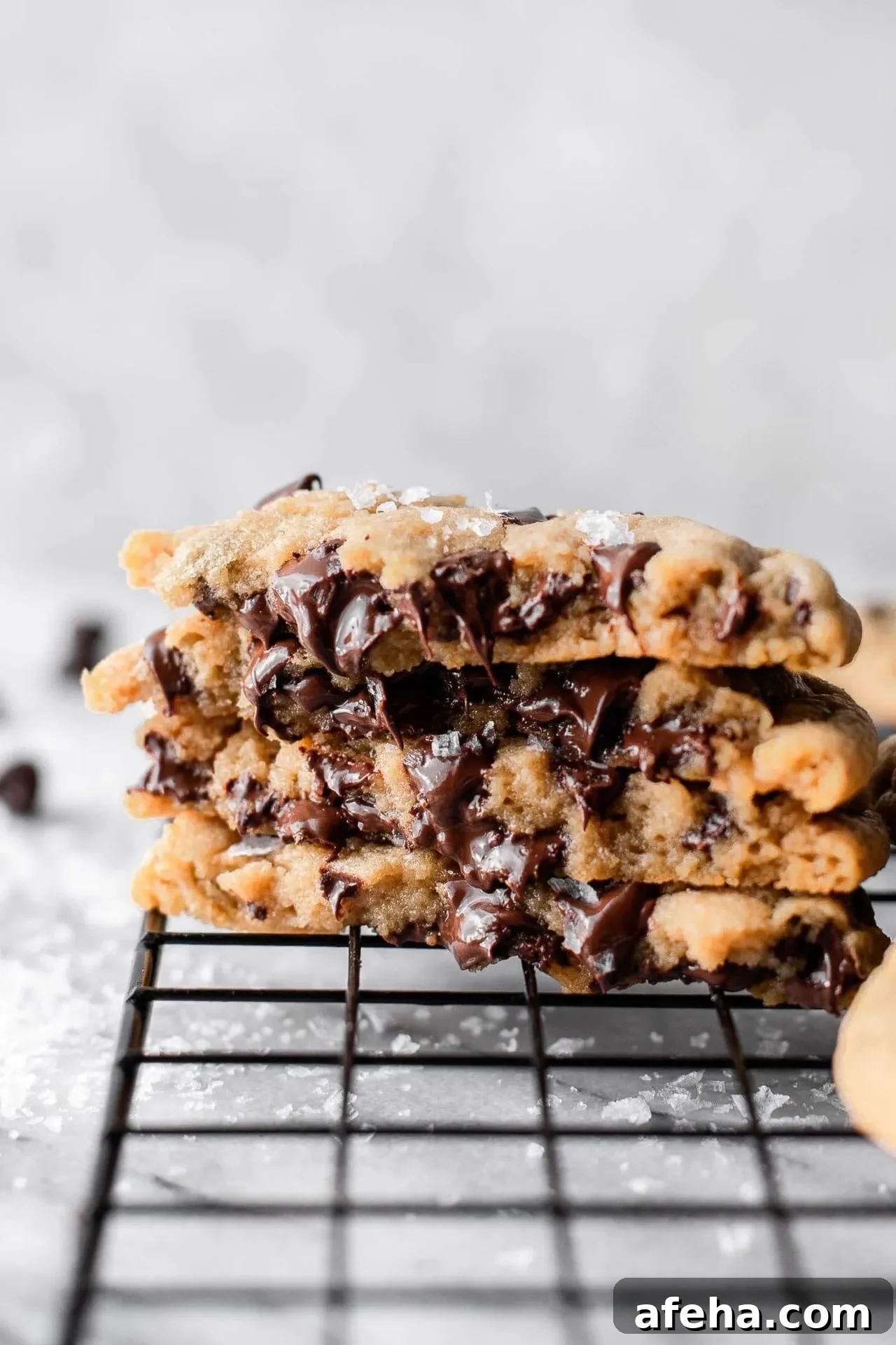 eggless chocolate chip cookies on wire rack with cookie halves stacked on top of each other