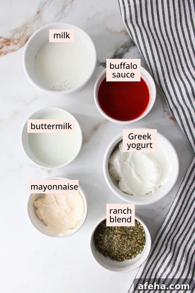 Ingredients for buffalo ranch sauce in small bowls with labels on a countertop.