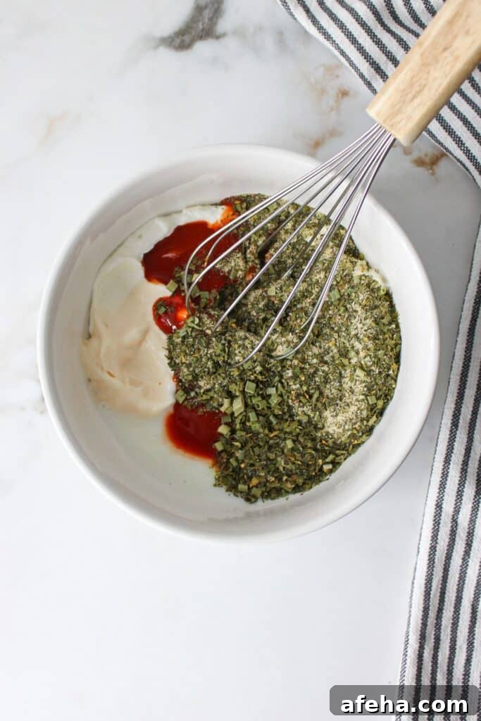 Ranch seasoning powder, Greek yogurt, buttermilk, buffalo sauce and mayonnaise in a bowl, unmixed.