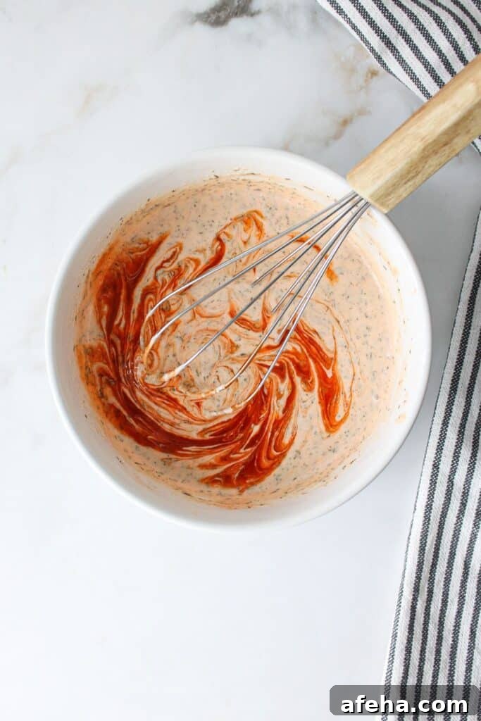 Mixed buffalo ranch sauce with a swirl of buffalo sauce on top.