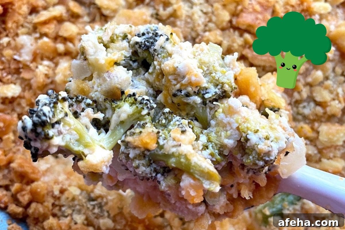 A close-up of a creamy broccoli casserole being served, showcasing tender broccoli florets and a crunchy topping.
