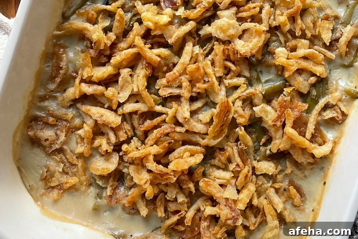 Close-up of a green bean casserole topped with crispy fried onions.