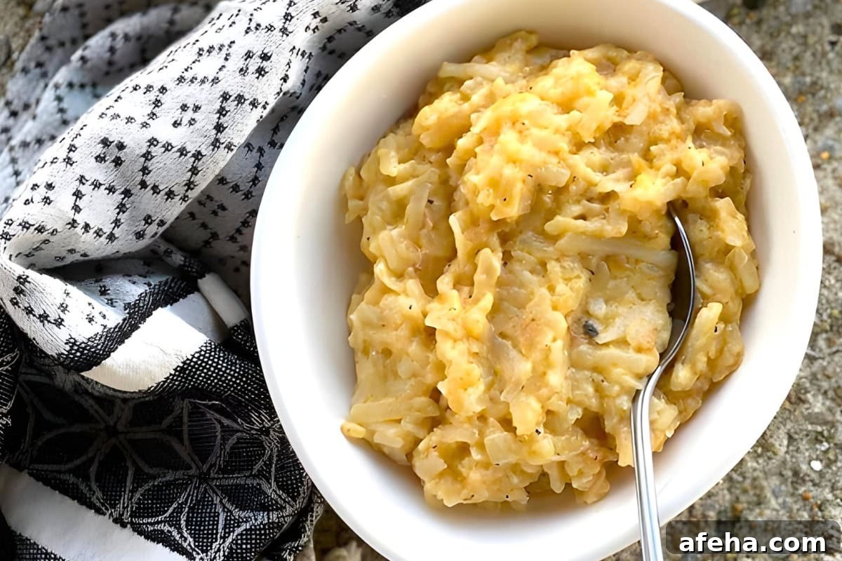 Crockpot cheesy hashbrown potatoes in a slow cooker.