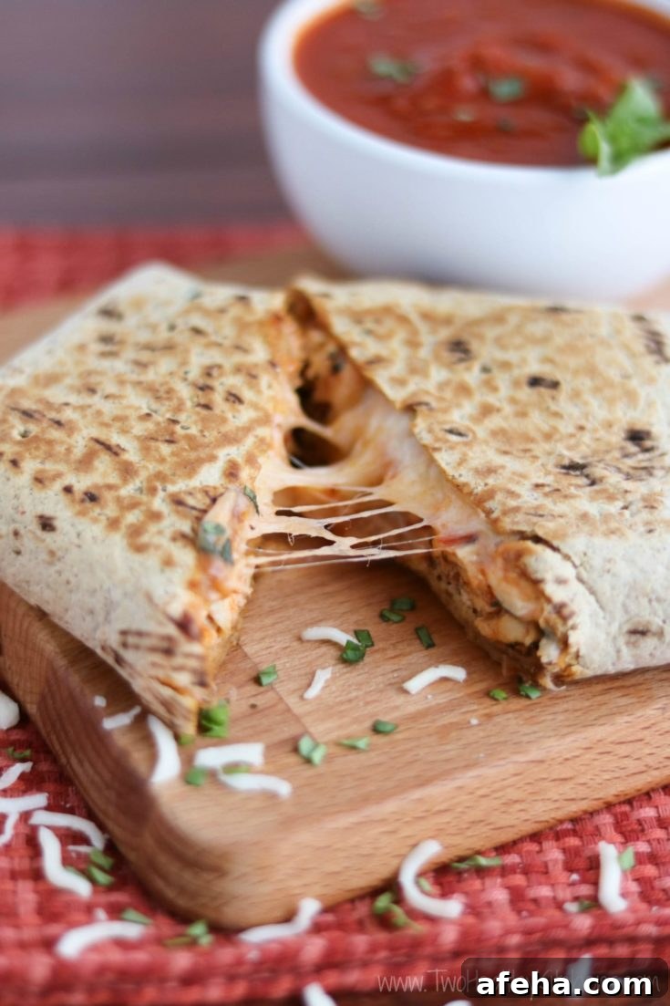 Cheese pull from warmed chicken parmesan wrap.