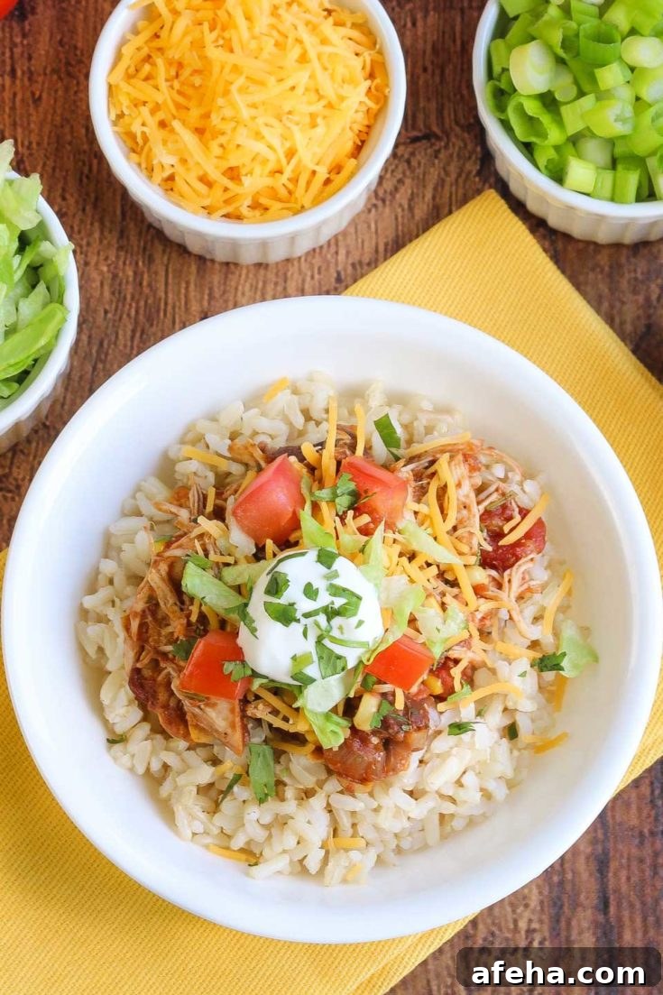 Table set with chicken burrito bowl and toppings.