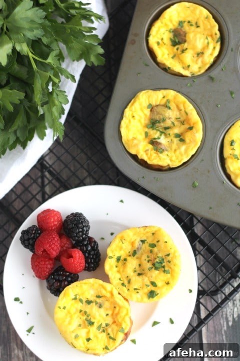 Two egg cups and berries on a small white plate