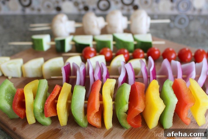 Skewers threaded with vegetables on a cutting board.