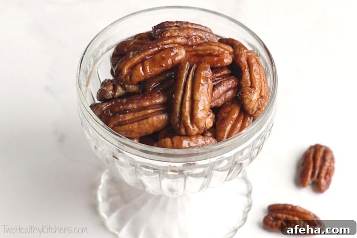 Glass parfait dish filled with candied pecans.