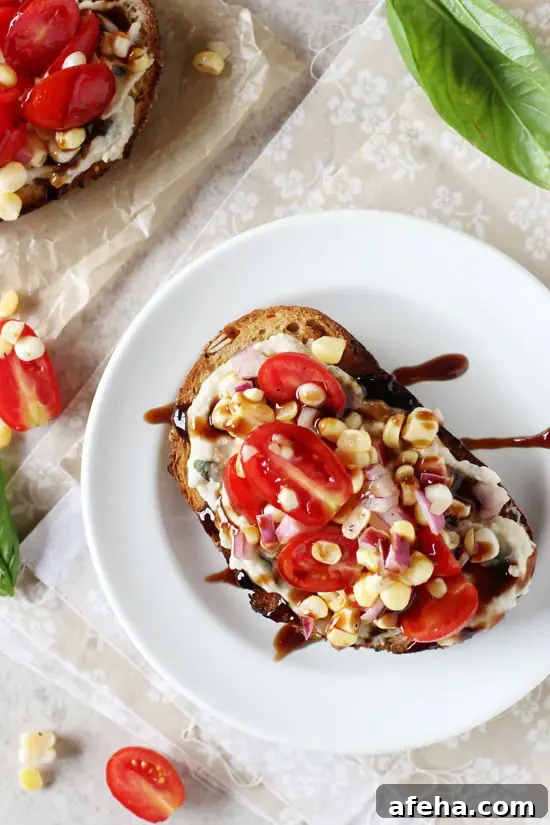A Tomato White Bean Sandwich on a white plate drizzled with balsamic glaze.