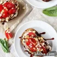 Recipe for quick and easy fresh corn and tomato open-faced sandwich. With a basil-packed white bean spread, a corn and tomato topping and balsamic glaze!