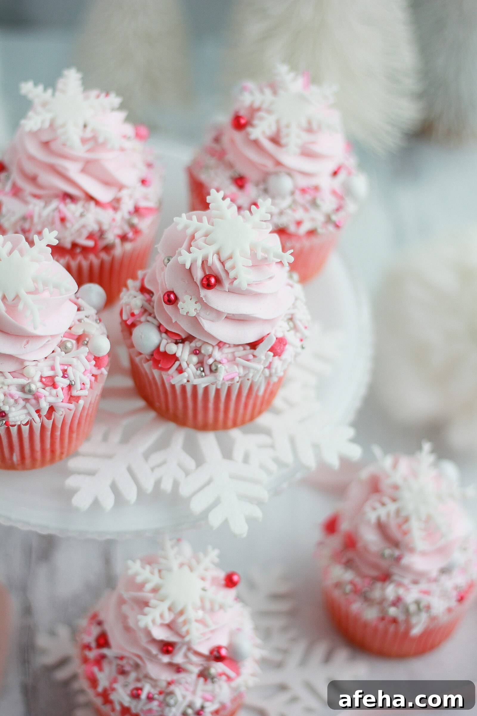 Pink Winter Wonderland Cupcakes: Festive Whipped Frosting Recipe 5 Cupcakes decorated with sprinkles and snowflakes