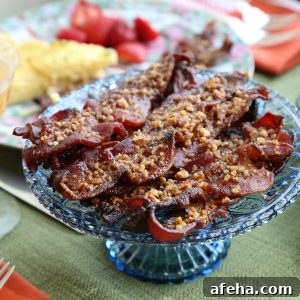 Praline-Crusted Candied Bacon — Sweet & Crunchy Bacon Recipe 10 praline bacon piled on a blue glass cake stand