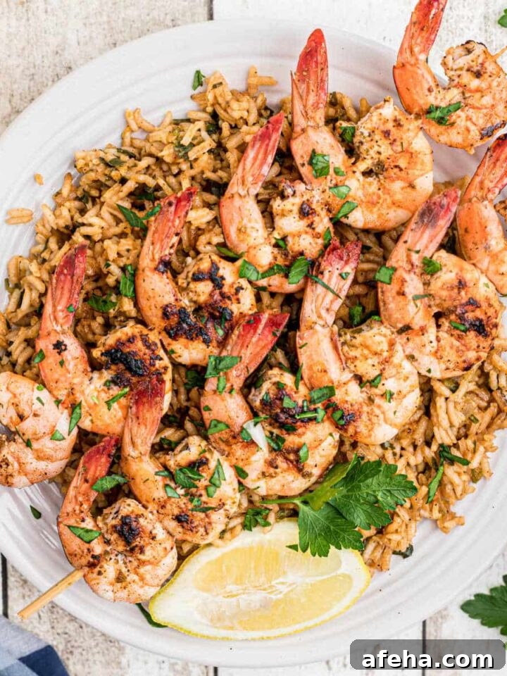 overhead shot of some texas roadhouse grilled shrimp on skewers on top of seasoned rice