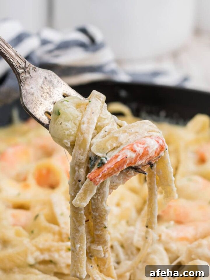 fork digging into shrimp alfredo bake pulling out the noodles