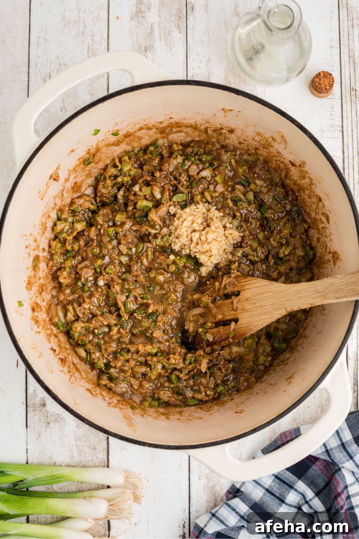 Garlic on top of other ingredients in a large pot.