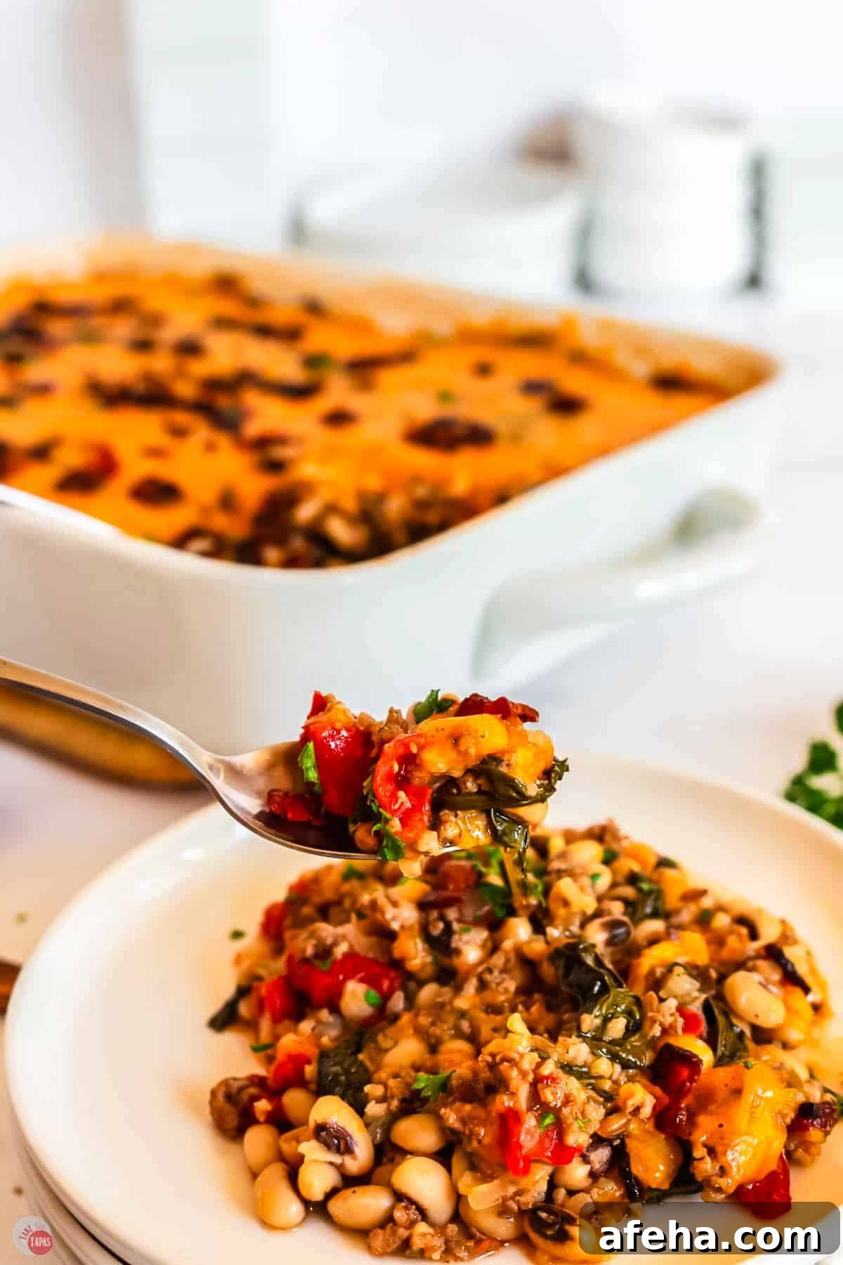 spoon of casserole over a dish