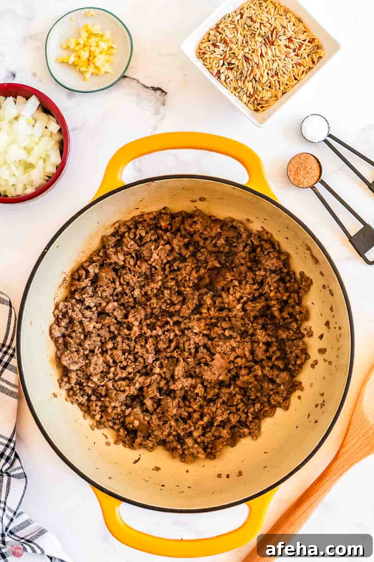 cooked ground sausage in a yellow pot