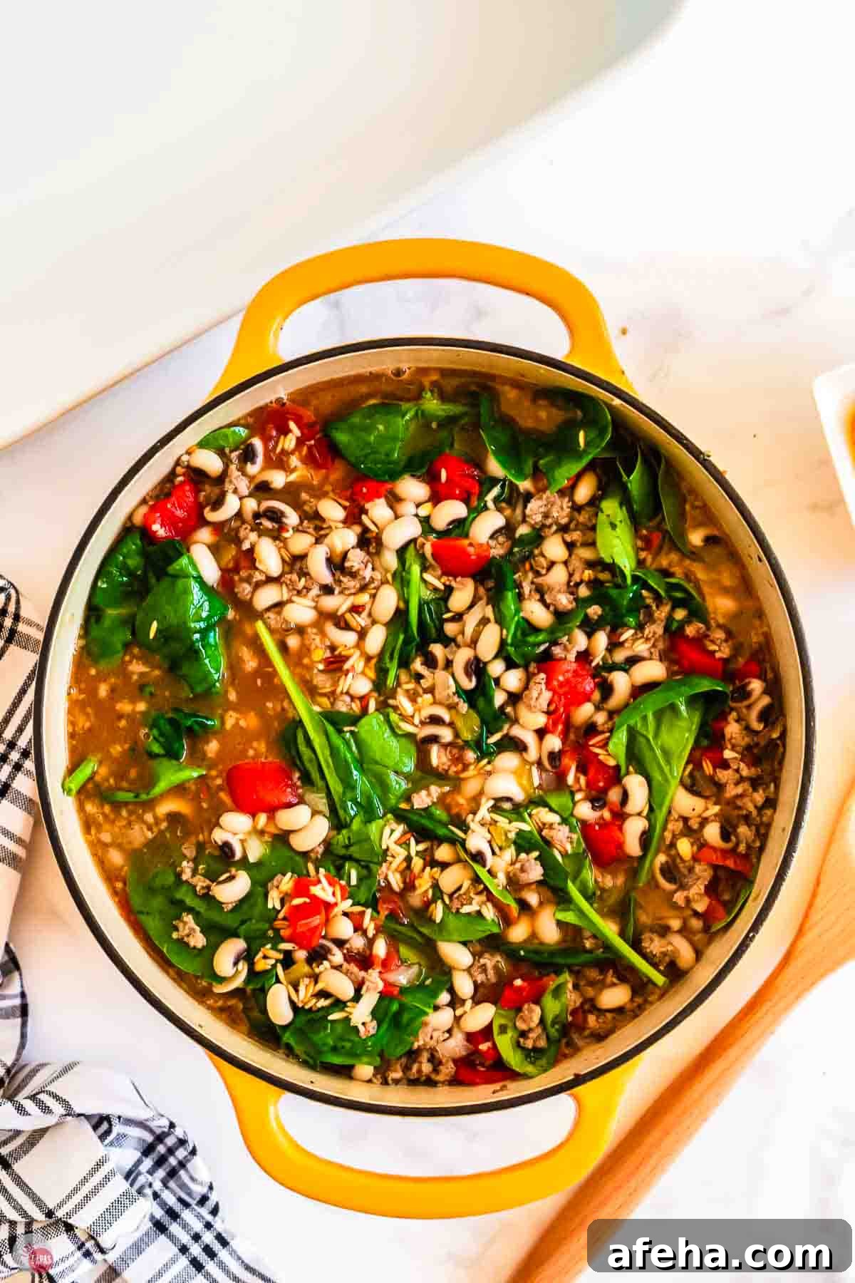 pot of black eyed peas with spinach and tomatoes
