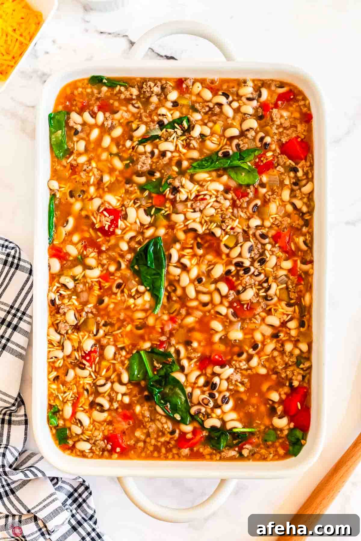 place black eyed peas and pork sausage in a white casserole dish