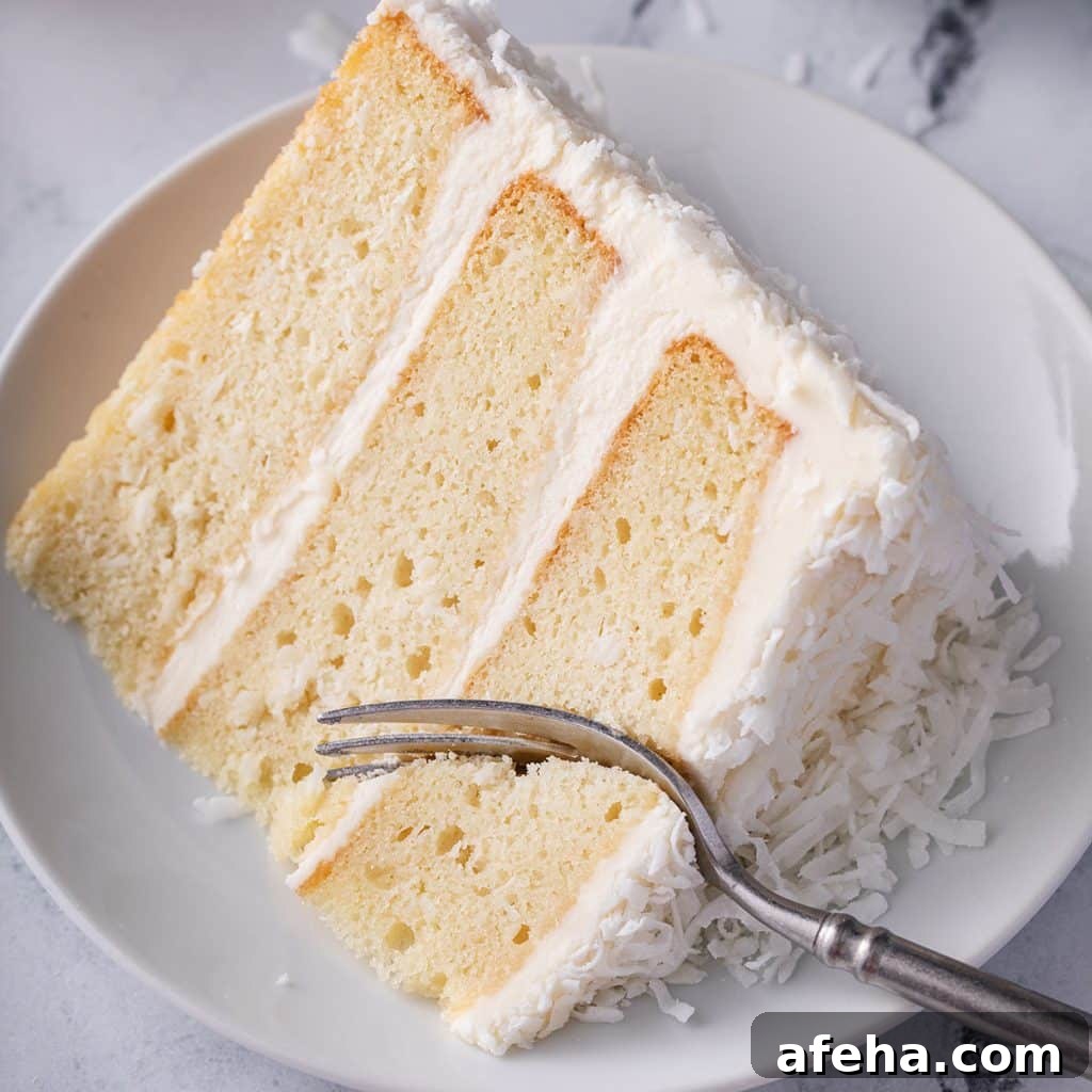 slice of white coconut cake on its side on plate