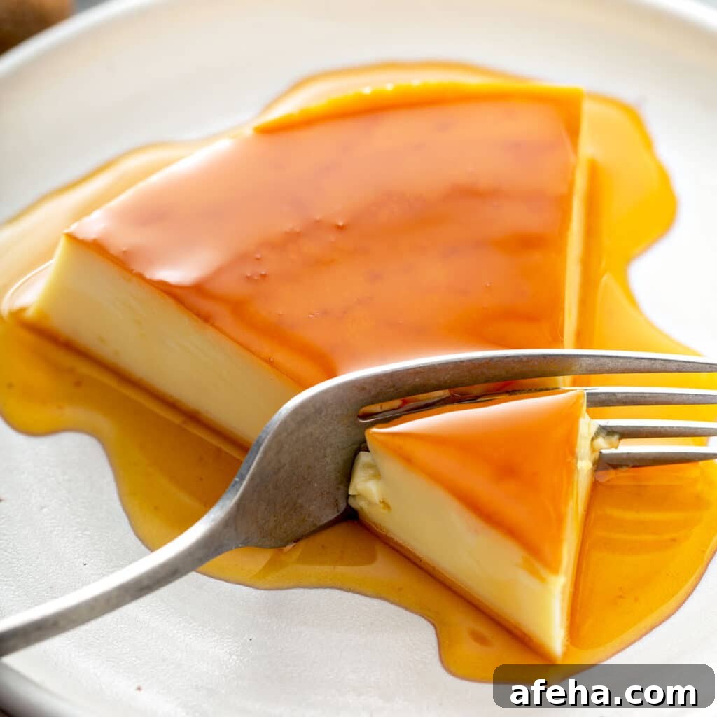 Rich and creamy flan with caramel on a white plate