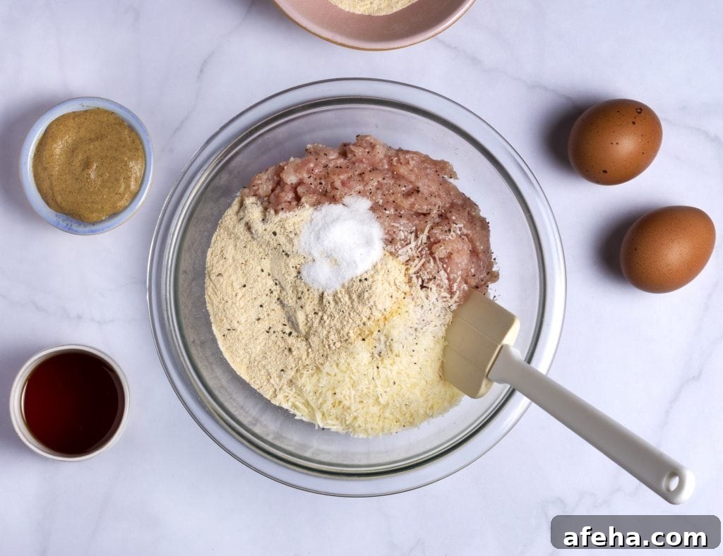 mixing the ground chicken and seasonings for chicken meatloaf