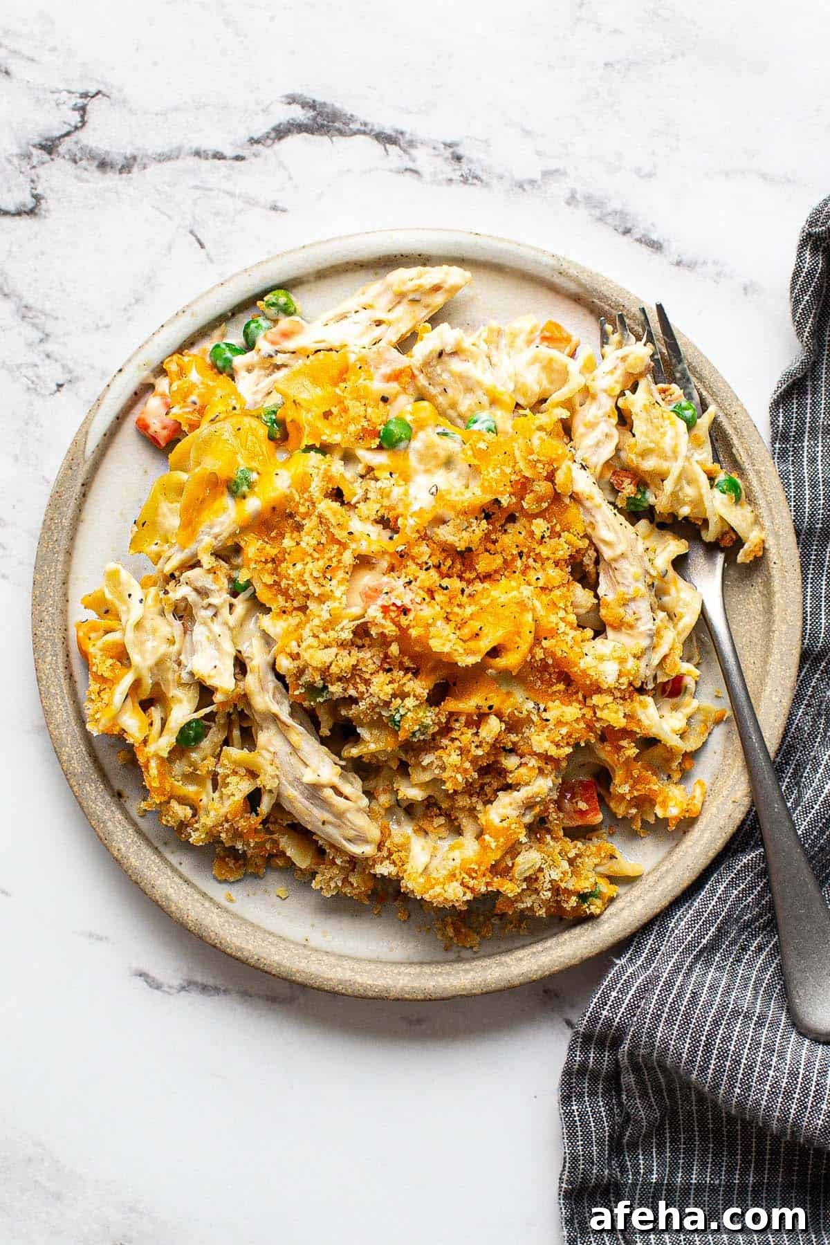 Comforting Chicken Noodle Soup Casserole Recipe 2 Plate of chicken noodle casserole with a fork.