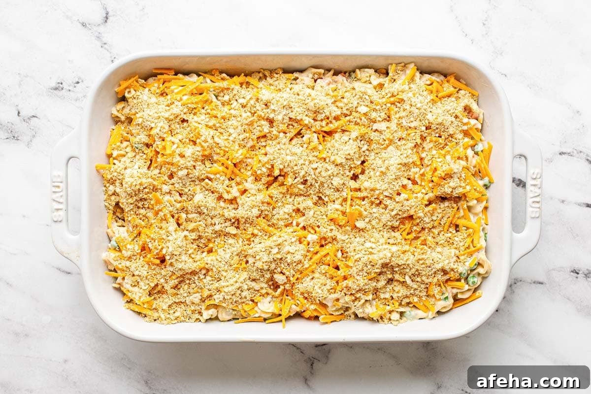 Comforting Chicken Noodle Soup Casserole Recipe 7 Chicken noodle casserole topped with cheese and crushed Ritz crackers.